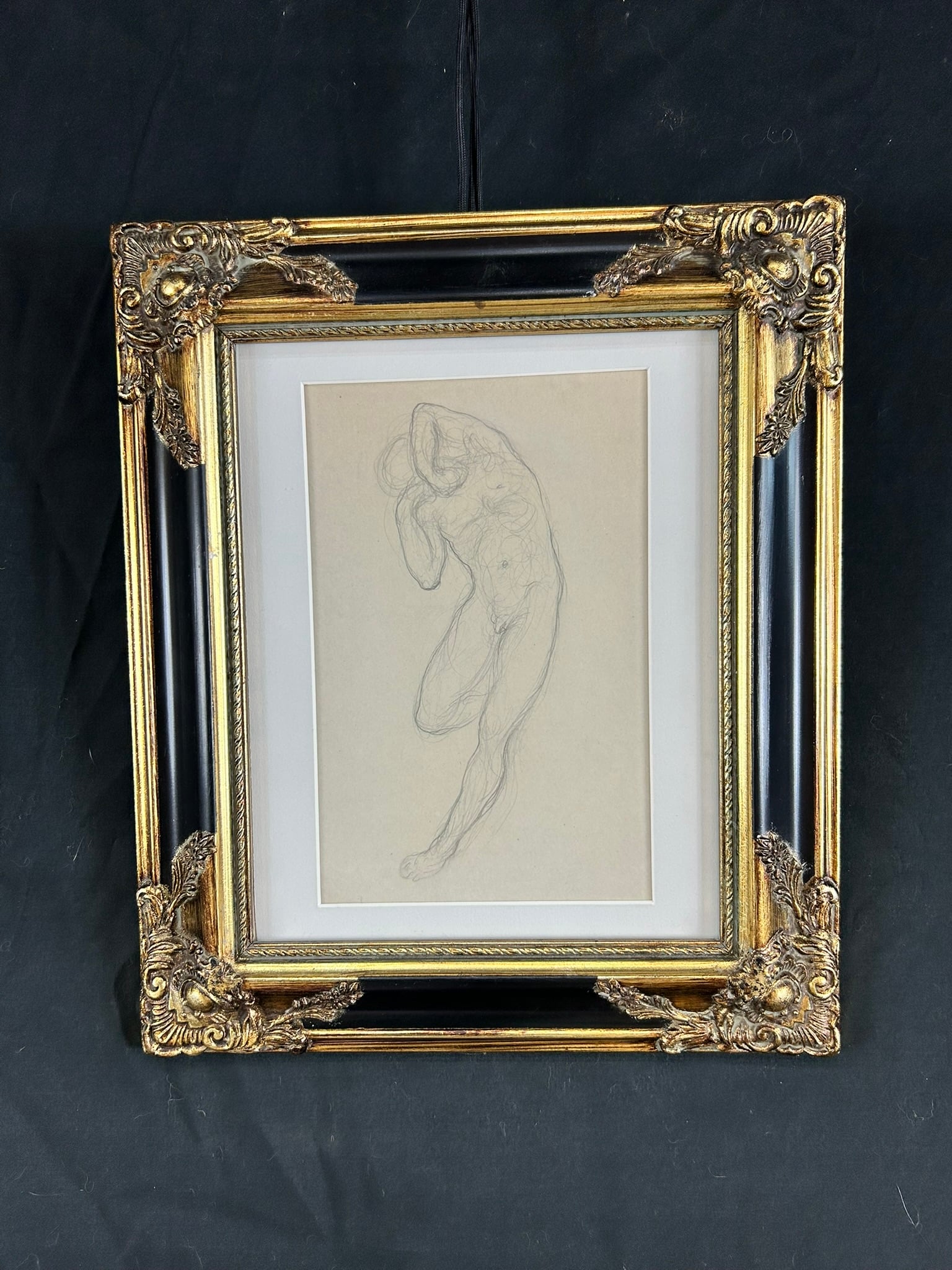 Graphite sketch of a standing male nude, attributed to American artist Khalil Gibran, framed in ornate gold and black.